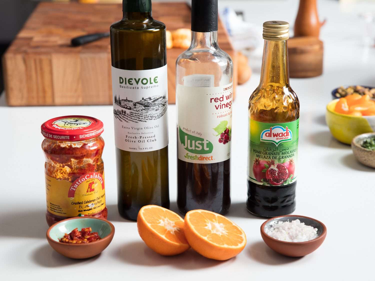Ingredients for the vinaigrette: crushed Calabrian chiles in oil, extra virgin olive oil, red wine vinegar, pomegranate molasses, satsuma mandarin juice, and salt.