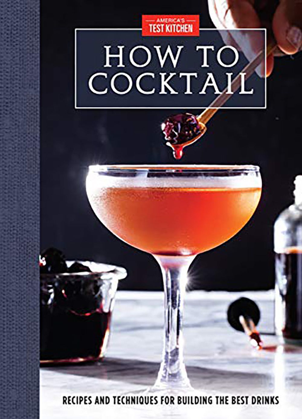 the cover of the book How to Cocktail featuring a Manhattan in a coupe glass with a cherry on a toothpick