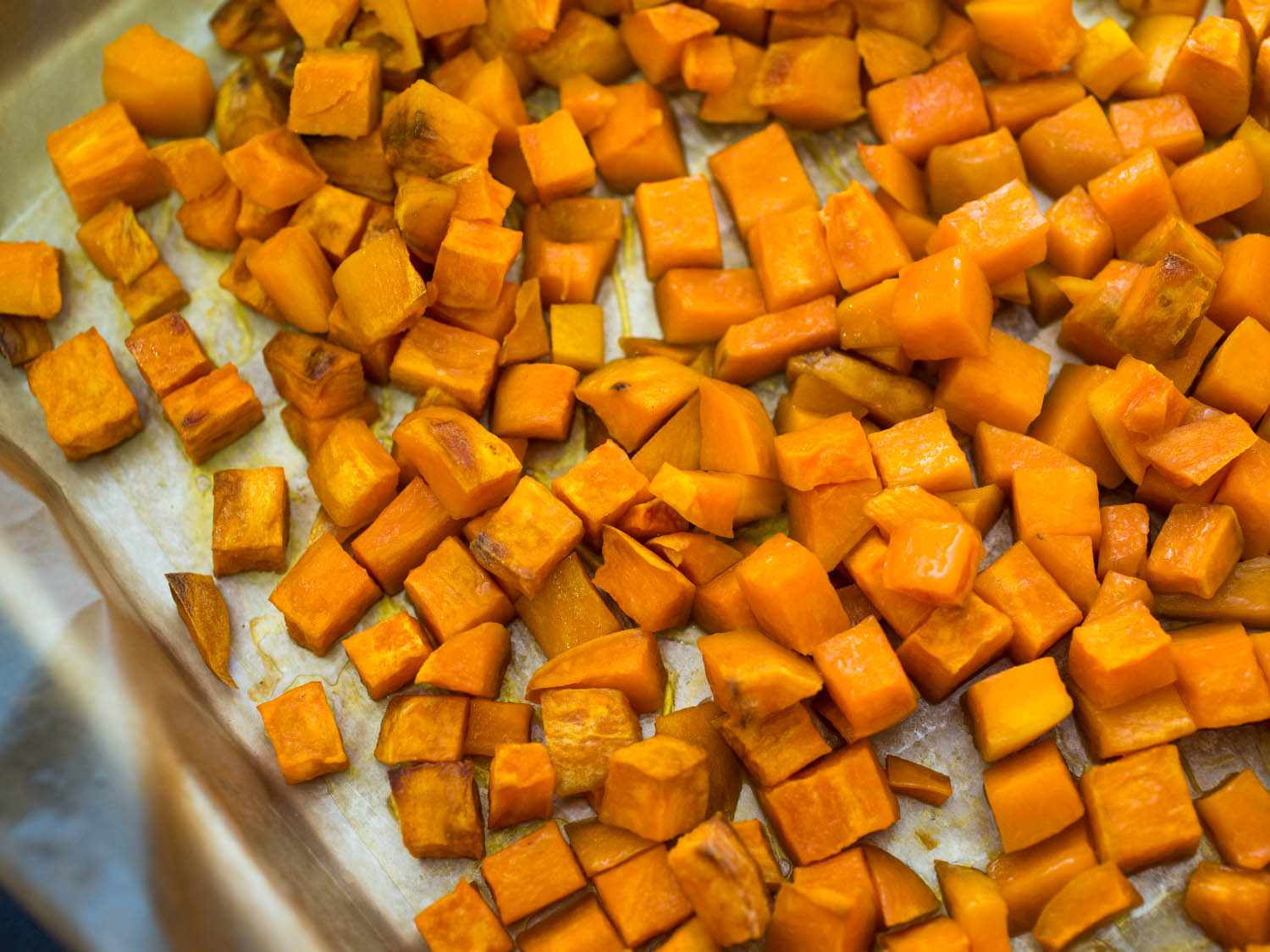 Sweet potato cubes on a baking tray. 