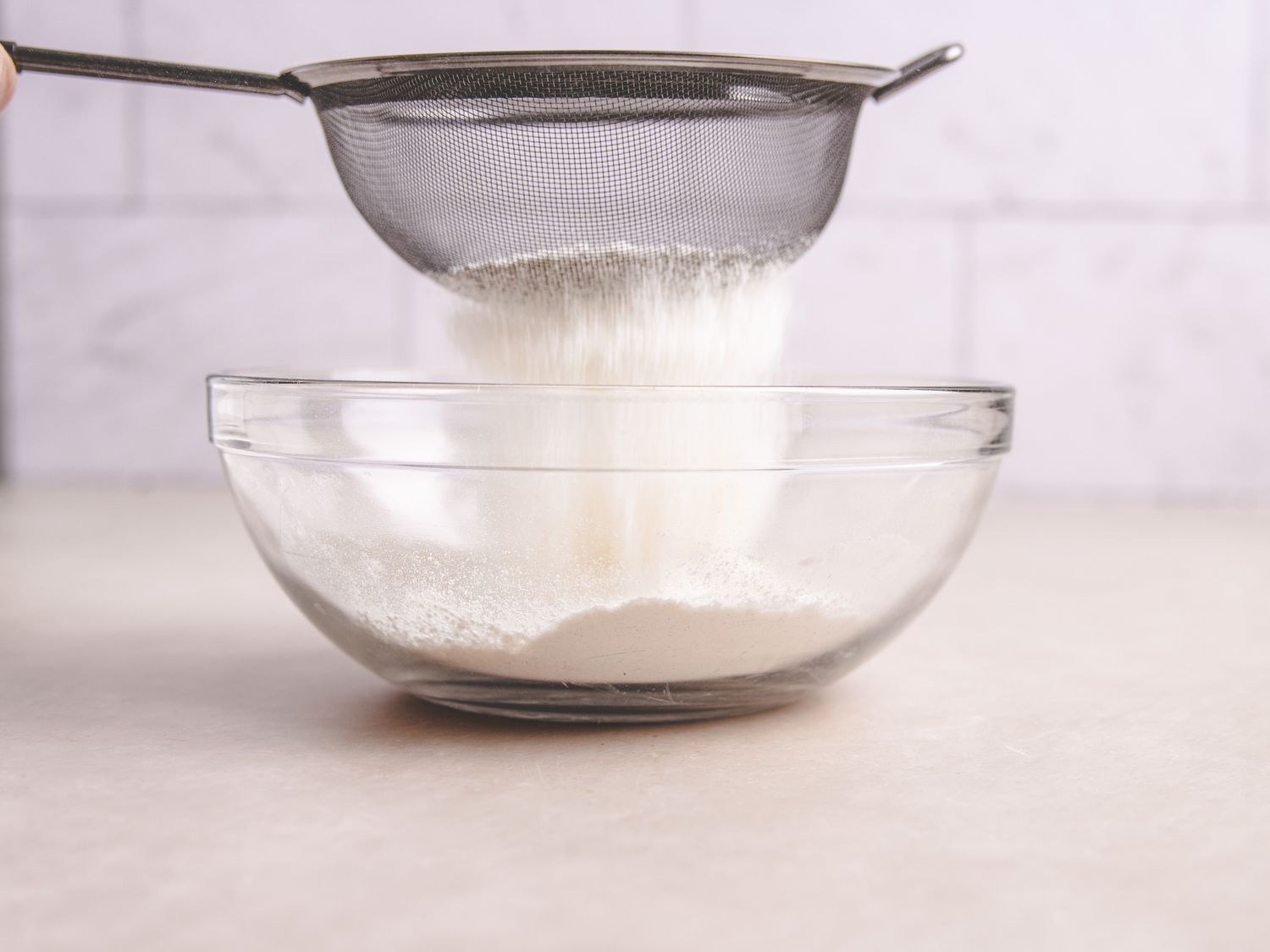 Sifting flour and salt in bowl 