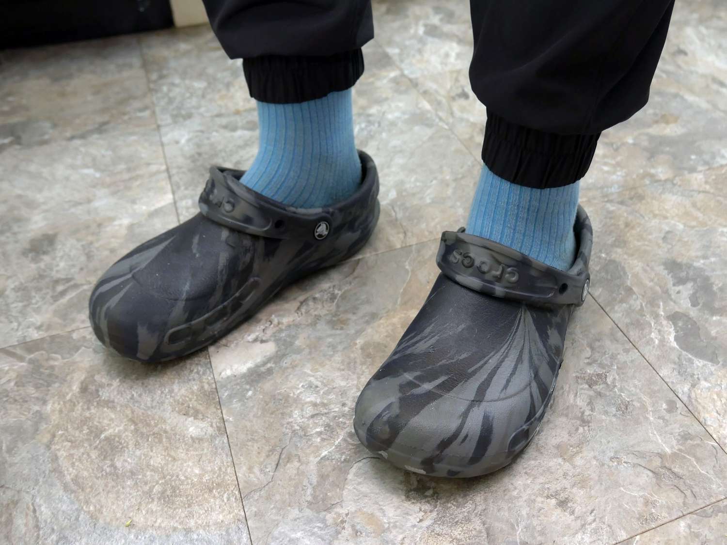 A person wearing Crocs bistro clogs.