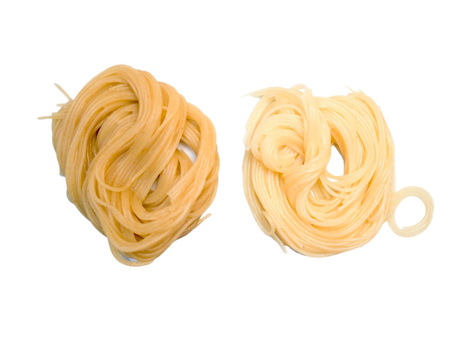 Side by side comparison of angel hair pasta cooked with baking soda and without. The pasta cooked with baking soda has a deeper yellow color. 