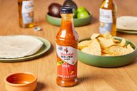 Nando's Extra Extra Hot Peri Peri Sauce (4-Pack) on table