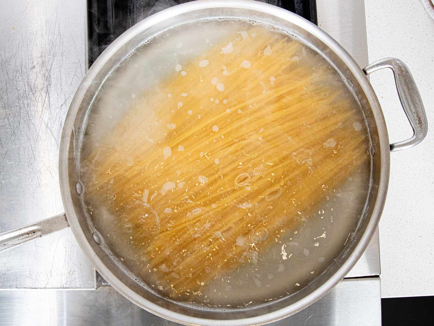 Overhead view of adding pasta