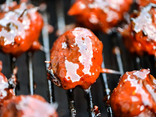 MOINK meatballs glazed with barbecue sauce on the grill.