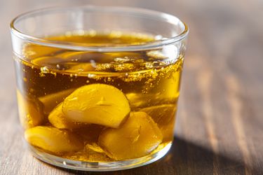 Garlic cloves in oil in a glass container