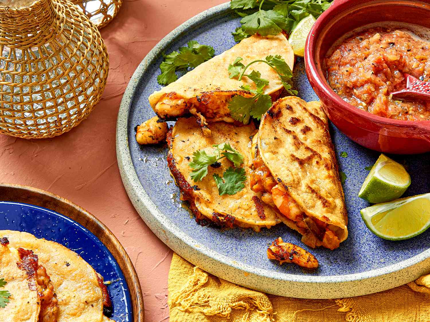 Tacos gobernador plated with salsa and lime wedges