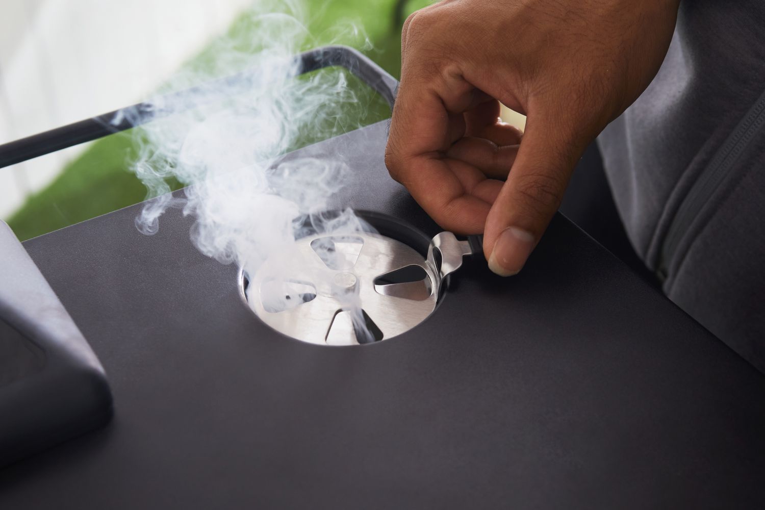 Hand adjusting the smoke release on the Masterbuilt MB20072918 40-Inch Digital Electric Smoker