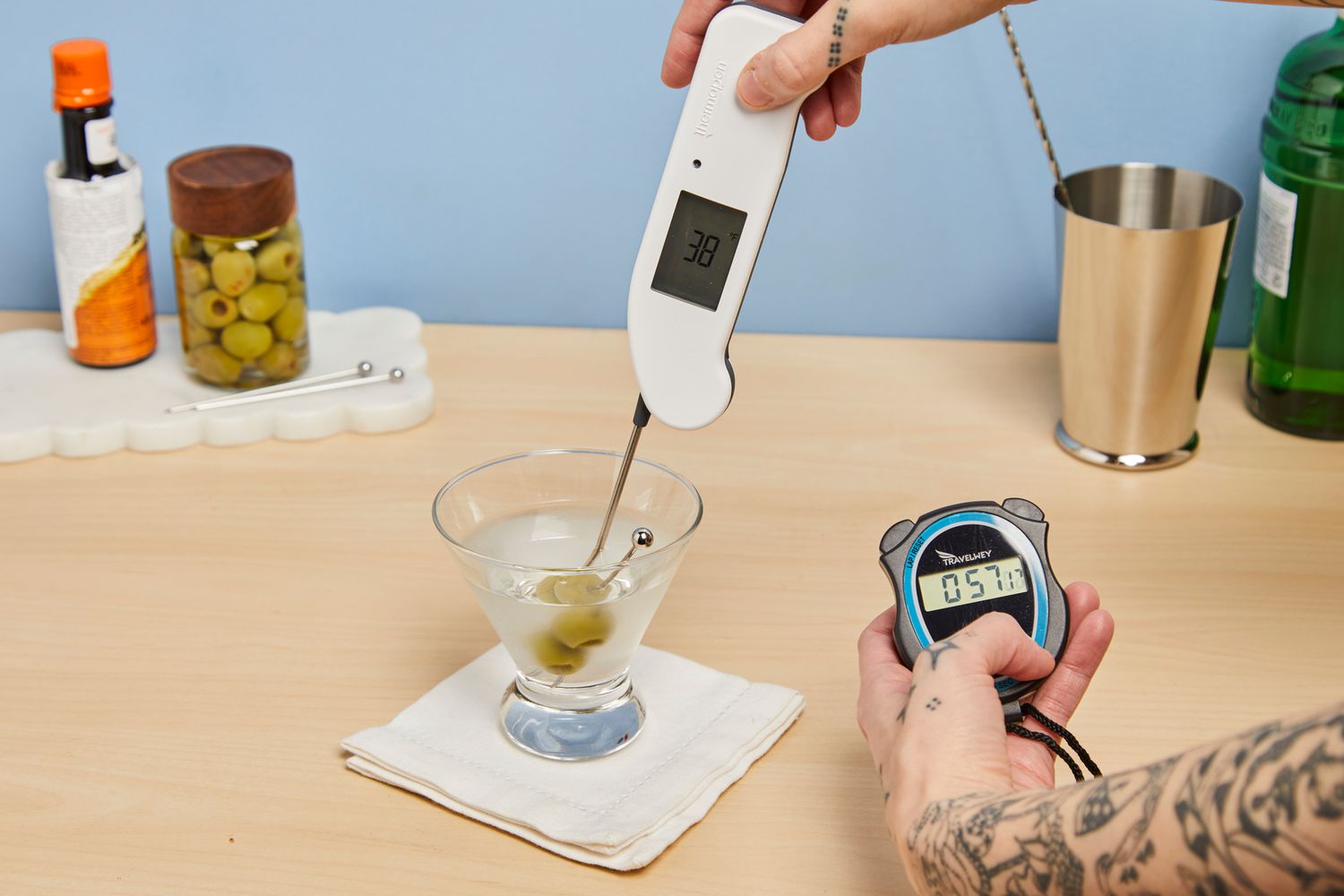Person putting thermometer in Libbey Cosmopolitan Stemless Glass 