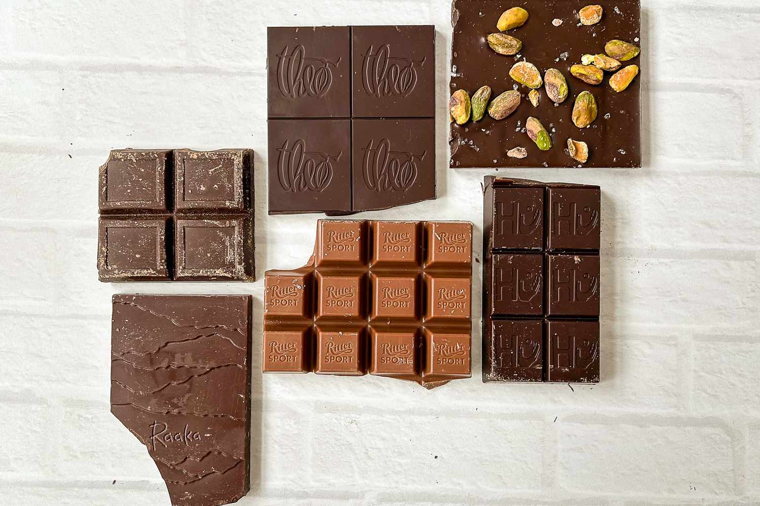 A collection of unwrapped chocolate bars on a white background
