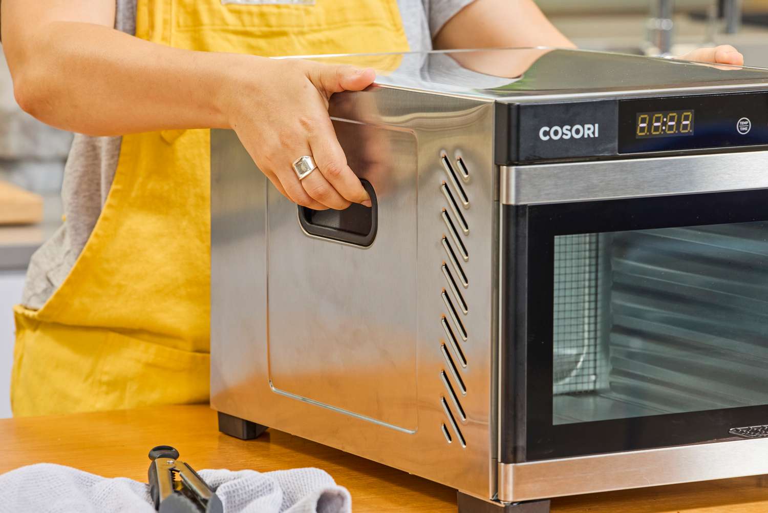 A person holding COSORI Food Dehydrator