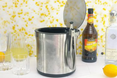 oxo ice bucket on a white tile surface