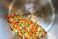Cooked vegetables in a stainless steel stockpot.