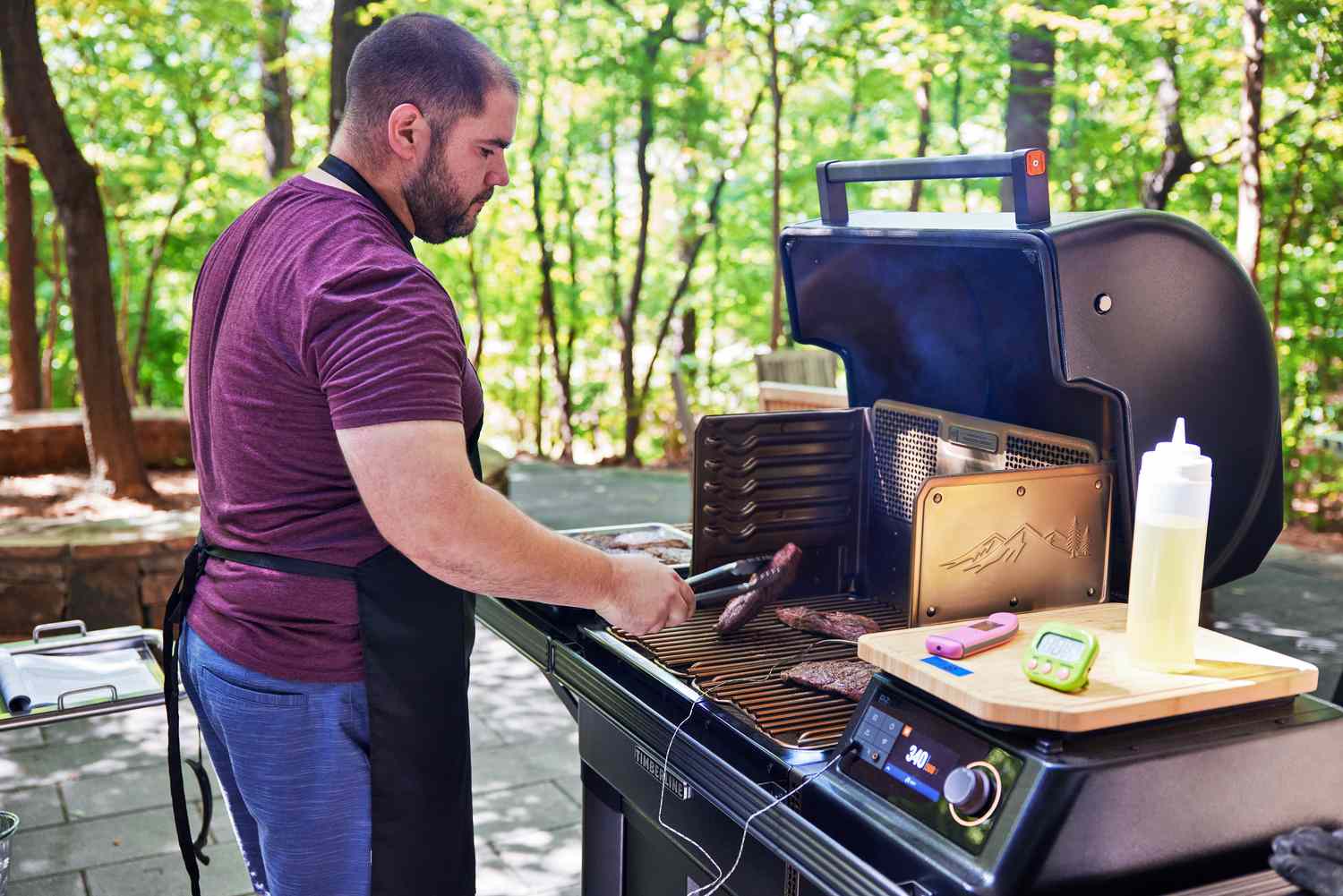 A person flipped food on a pellet grill