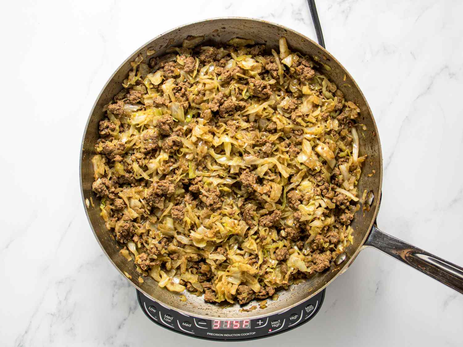 filling after cooked in a pan on heat, on a white marble surface. 