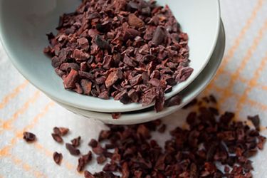 A small dish of cacao nibs. 