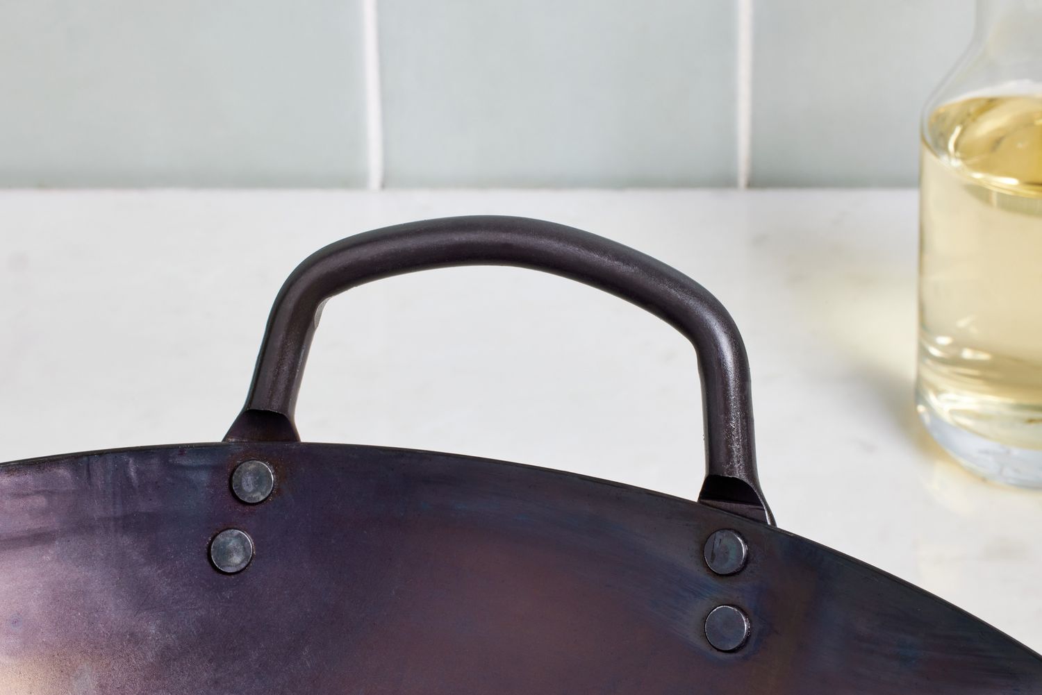 close up of handle on a Mammafong Pre-Seasoned Blue Carbon Steel Flat-Bottom Pow Wok