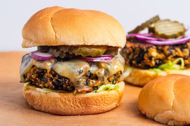 Black bean burgers with cheese, pickles, lettuce and red onions.