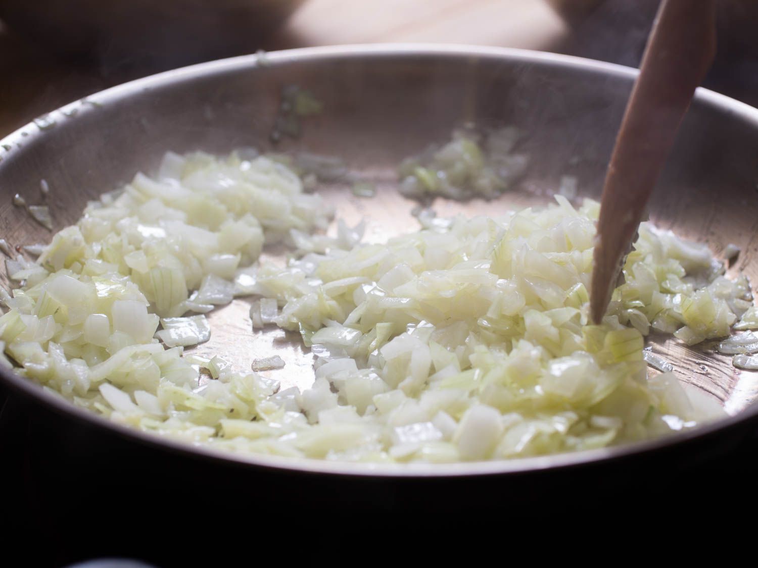 Onions and garlic being sautéed in a skillet.