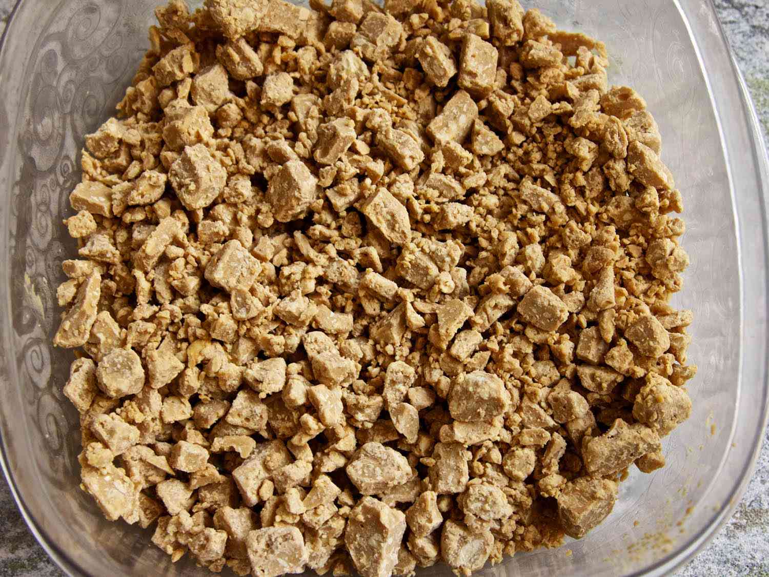 White chocolate peanut butter streusel in a baking dish. 