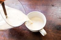 pouring almond milk into a mug
