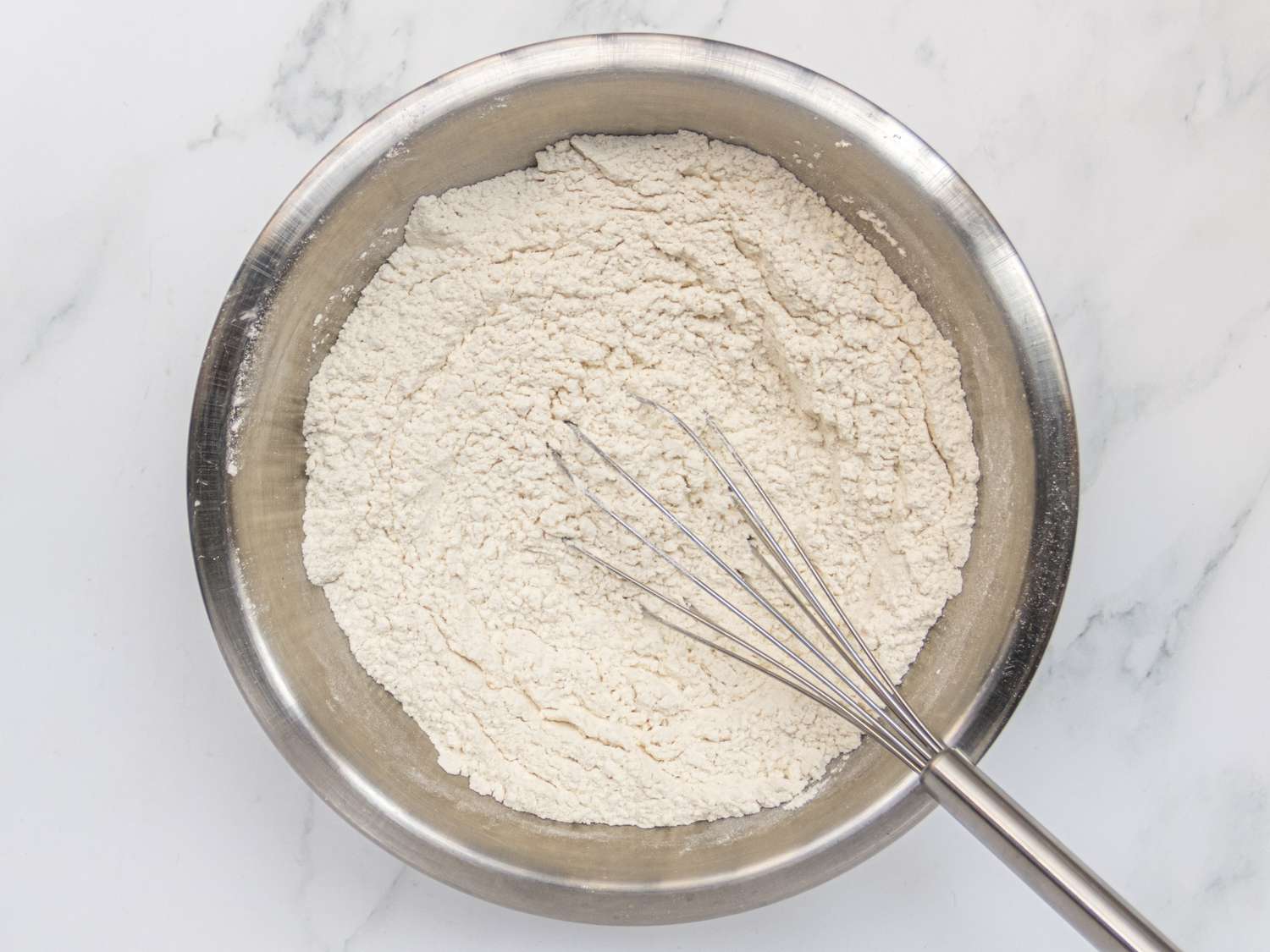 whisking dry ingredients for potato doughnuts