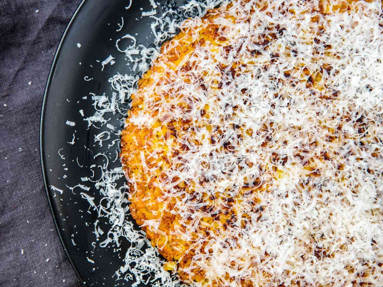 Risotto al salto showered with grated parmigiano.