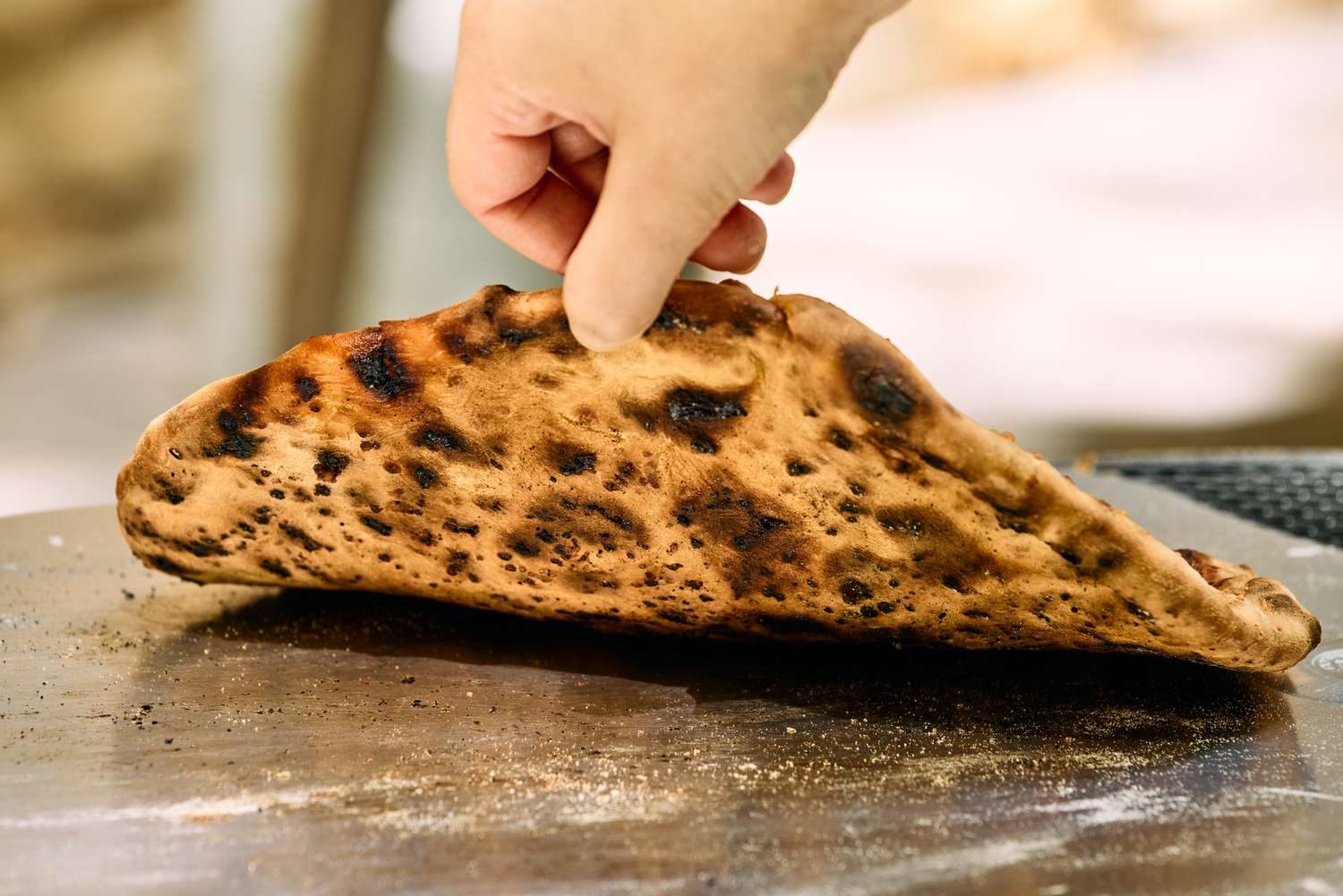 The bottom of a pizza cooked in the Ooni Karu 2 Pro Multi-Fuel Pizza Oven