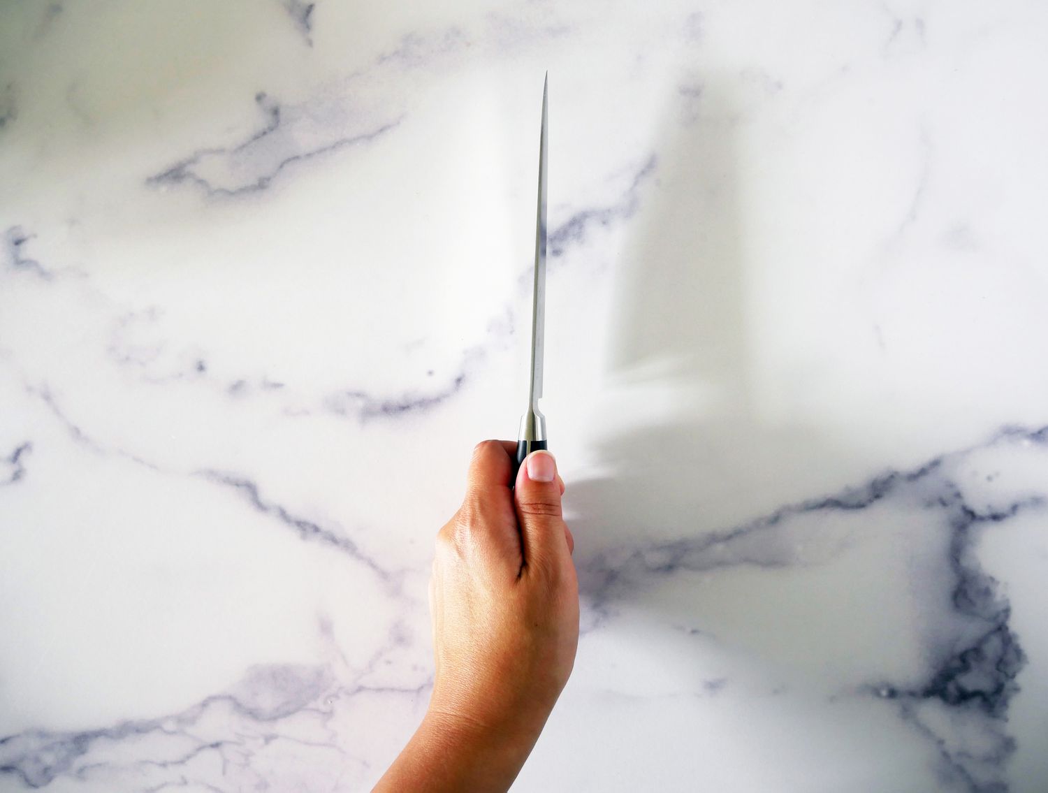 a hand holding a knife