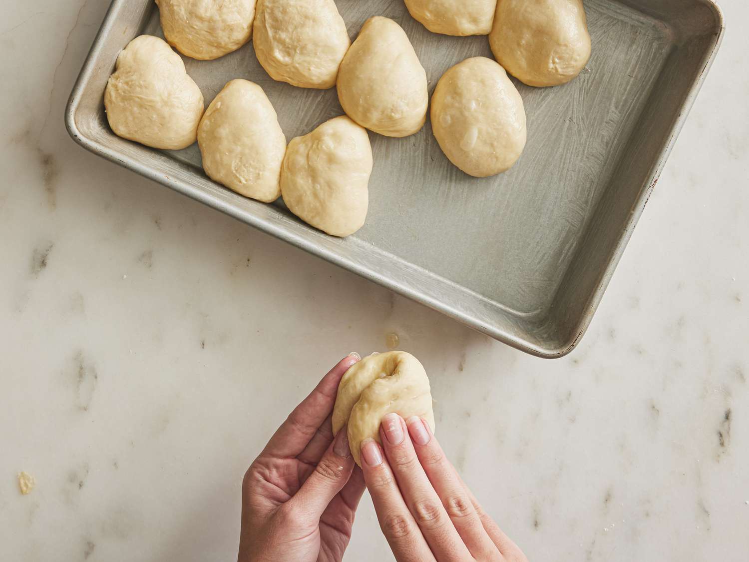 folding dough in half and replacing on a sheet pan
