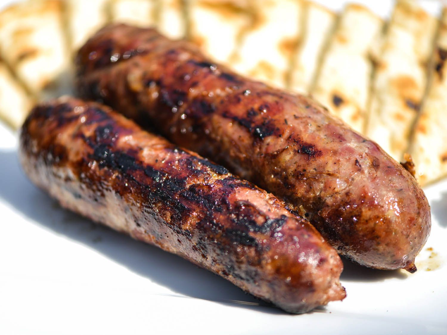 Charred loukaniko sausages, fresh off the grill.