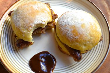 overhead shot of two bap sausage sandwiches on a plate