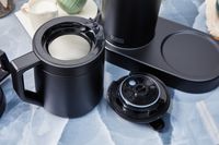 The carafe of the Ratio Six Coffee Maker.with its lid next to it 