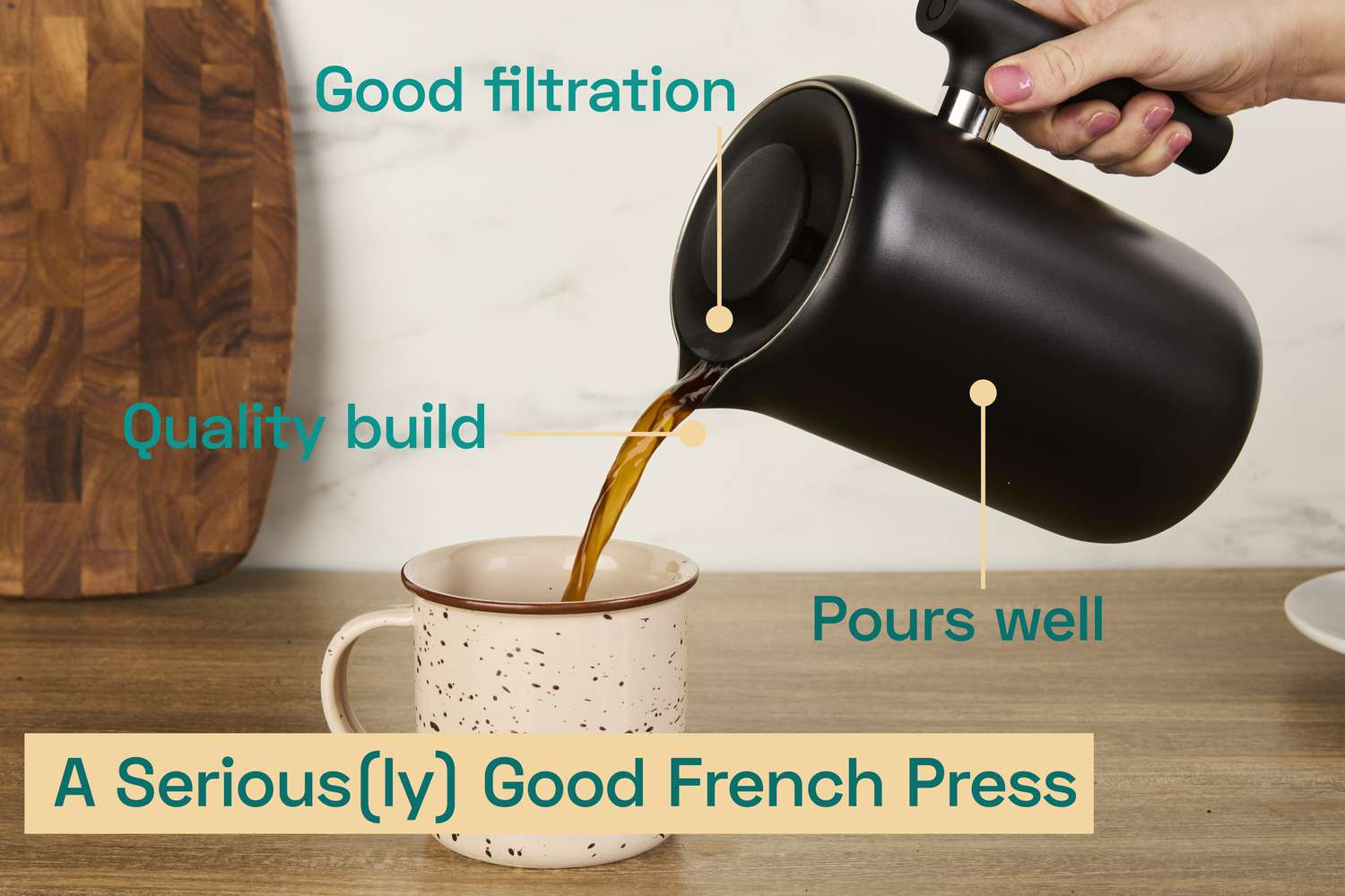 A person pouring coffee from the Fellow French press into a mug.