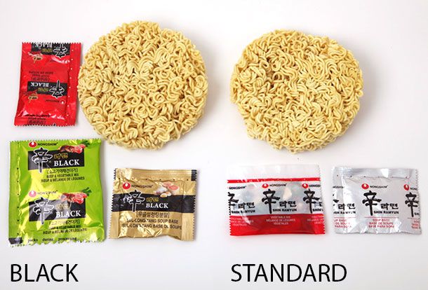 Two circles of dried ramen noodles with various flavoring packets.