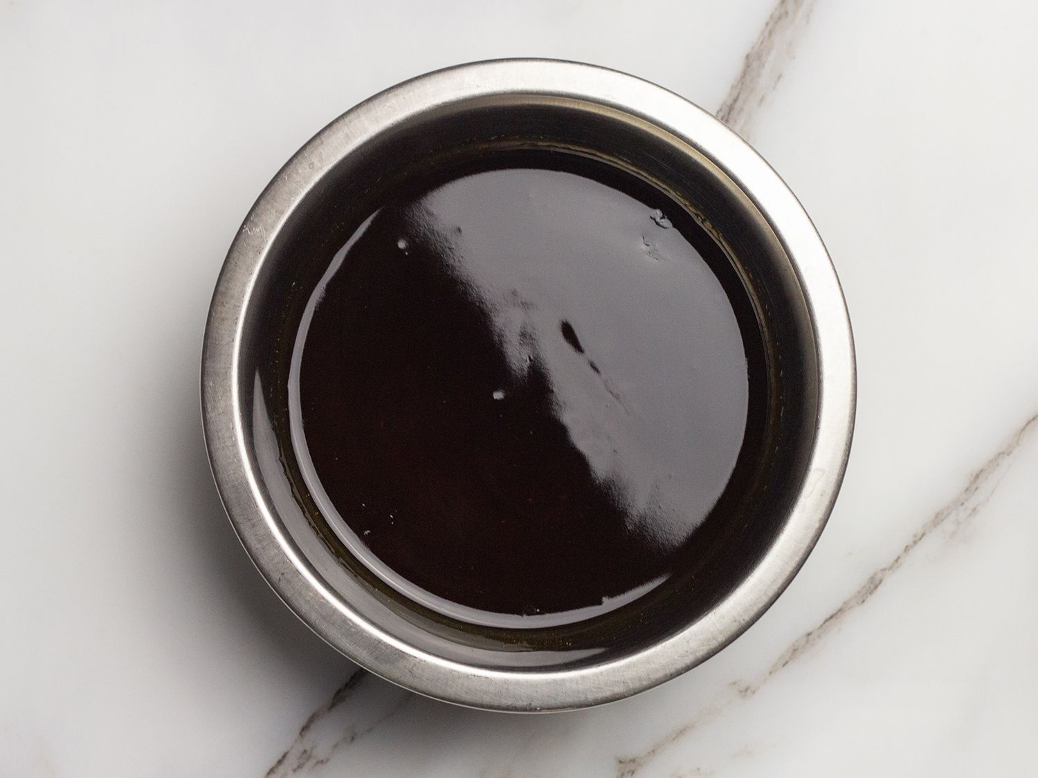 Overhead view of finished soy glaze in a small mixing bowl