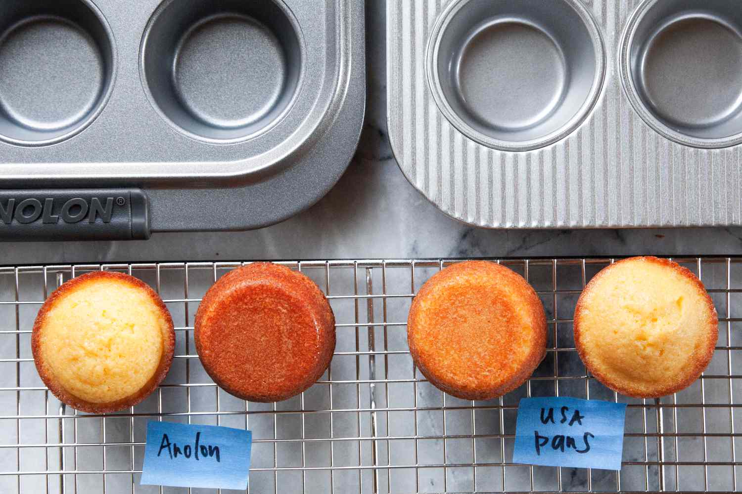 Muffins on cooling rack next to muffin pans