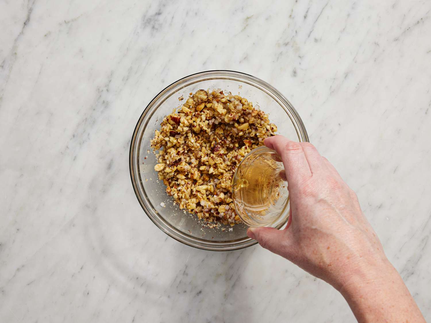 Pouring oil into dressing mixture