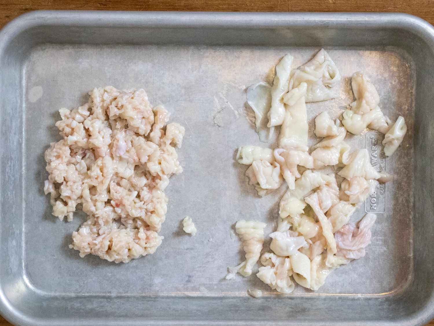 Minced chicken skin and chicken skin cut into strips on a rimmed baking sheet