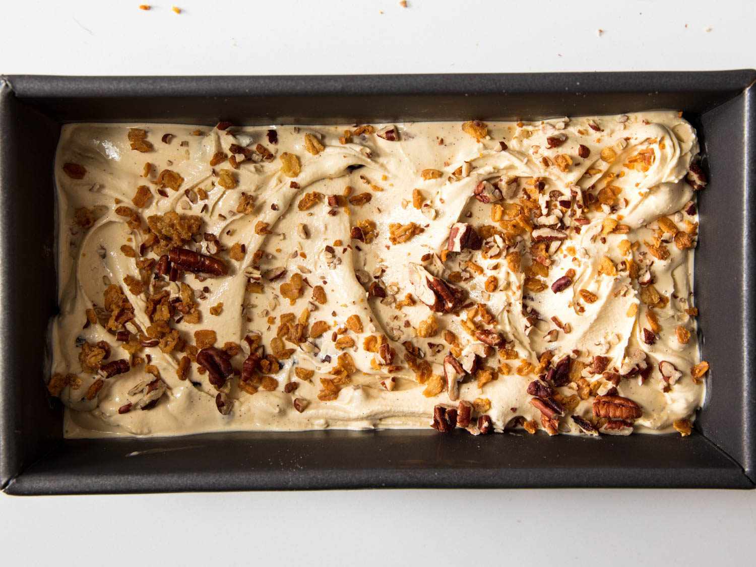 Loaf pan filled with topped oatmeal cookie ice cream.