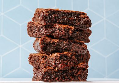 Stacked fudgy brownies with a geometric background