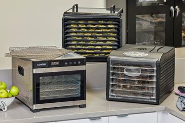 Three food dehydrators on a countertop