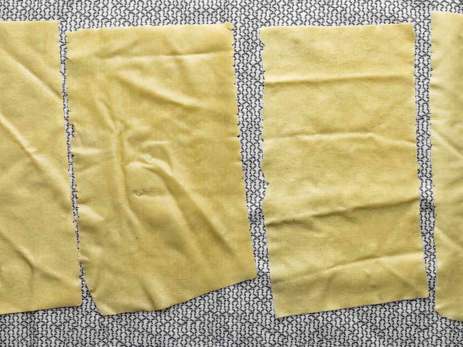 The cooked lasagna laid out on a dish towel to cool.