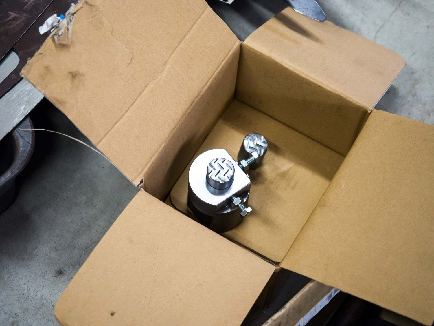 Overehad view of a cardboard box with the bladesmith's stamp.