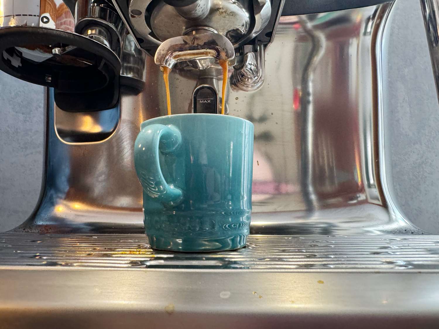 Espresso being brewed into a Le Creuset espresso cup.
