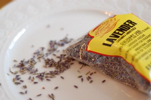 A bag of dried lavender is opened and poured out onto a plate.