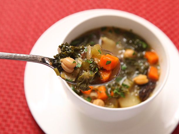 Closeup of spoonful of hearty winter vegetable soup 