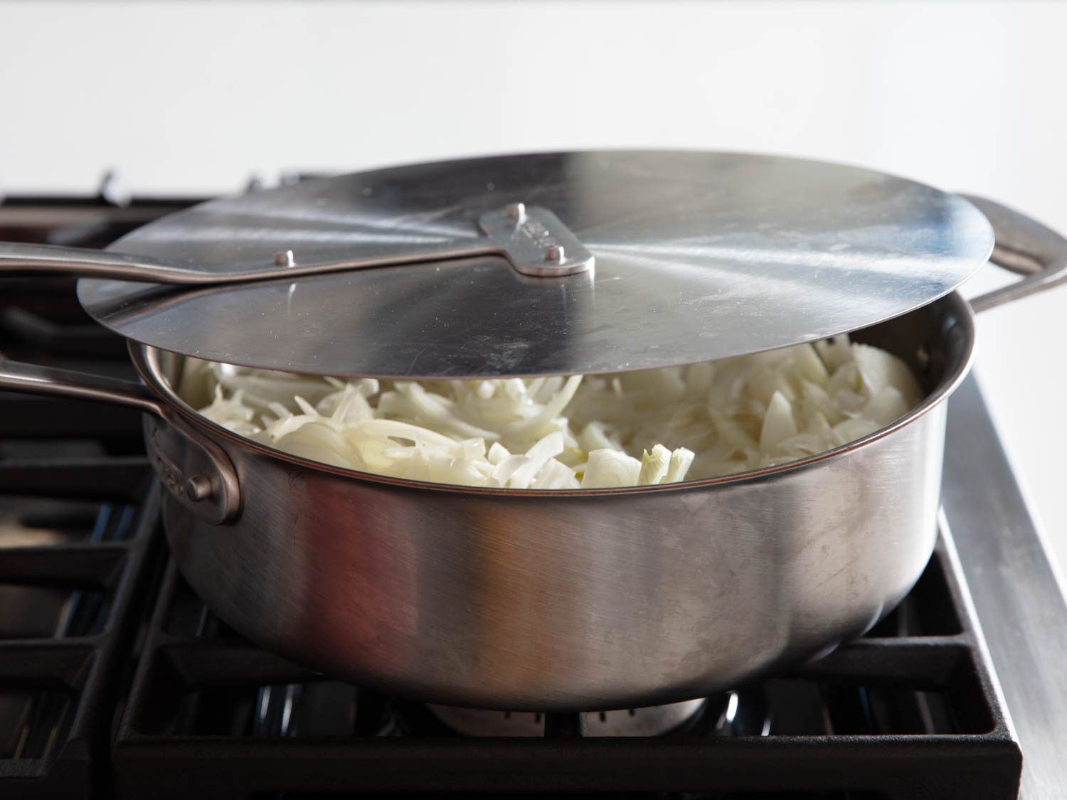 Putting a lid on the pan to speed up caramelized onions.