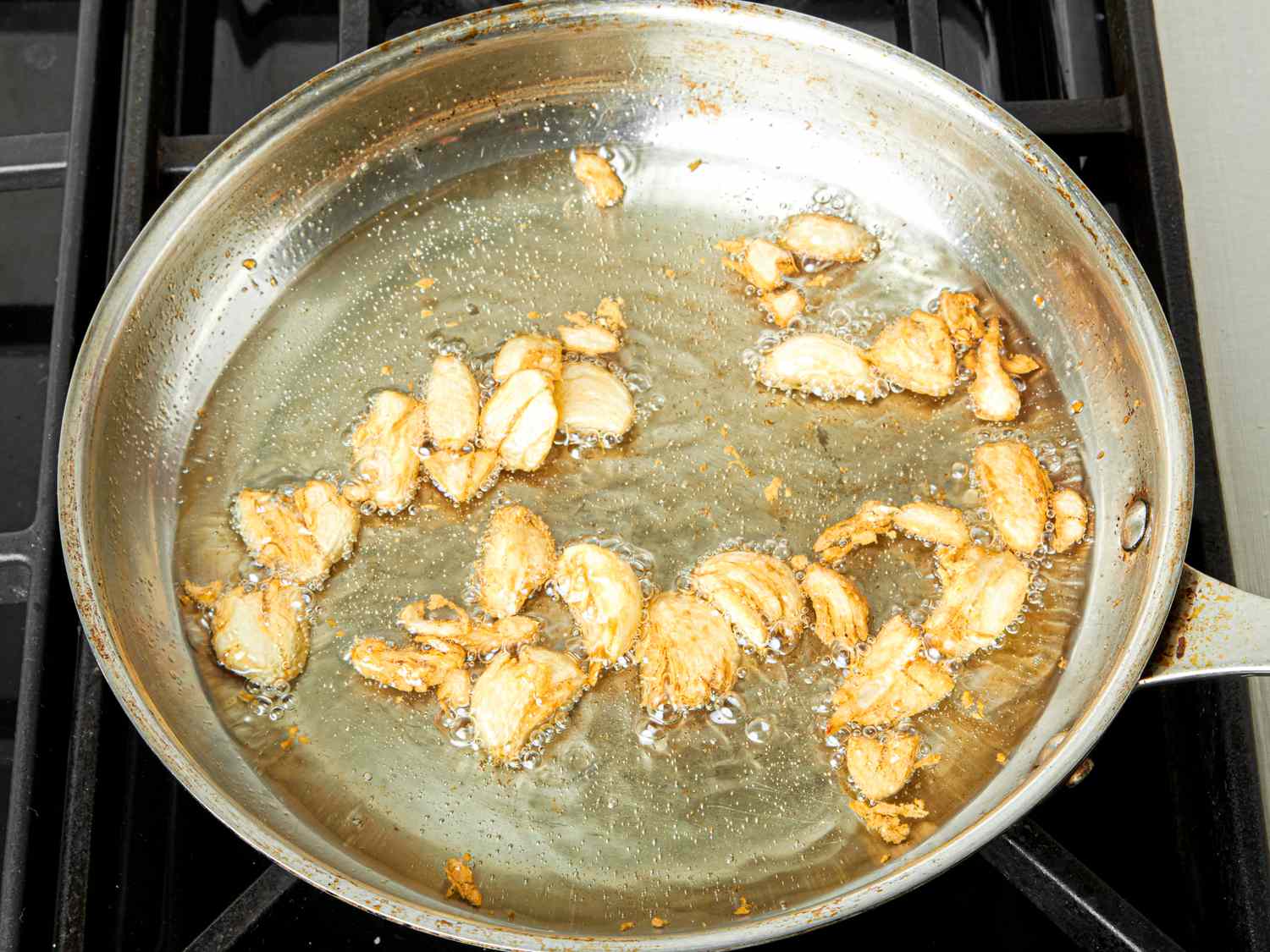 Overhead view of cooking garlic in a pan