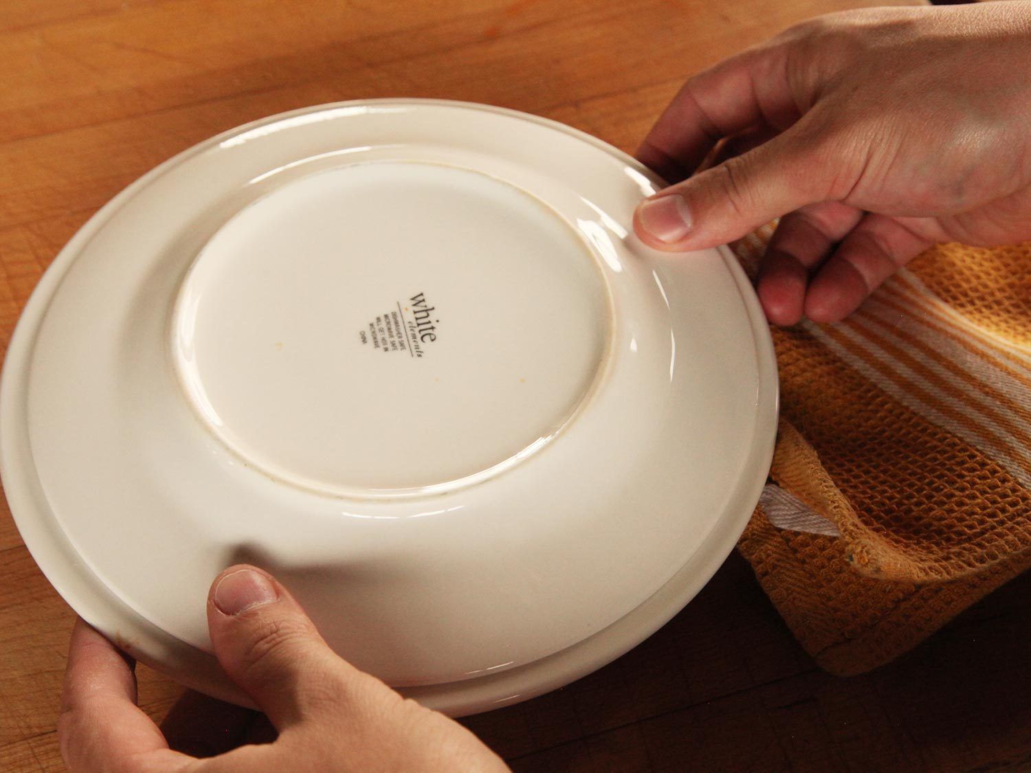 Covering a bowl of frozen dumplings before microwaving.